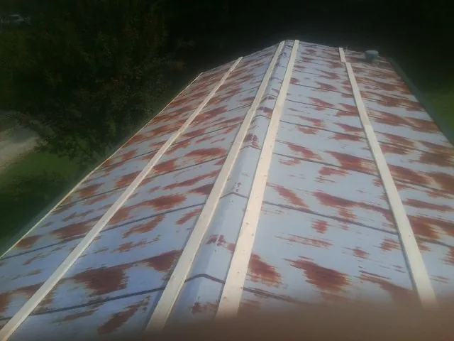 Rusted metal roof panels with new wood purlins before replacement — Storm Damage Roof Repair in Greenwich by Roofing Brothers